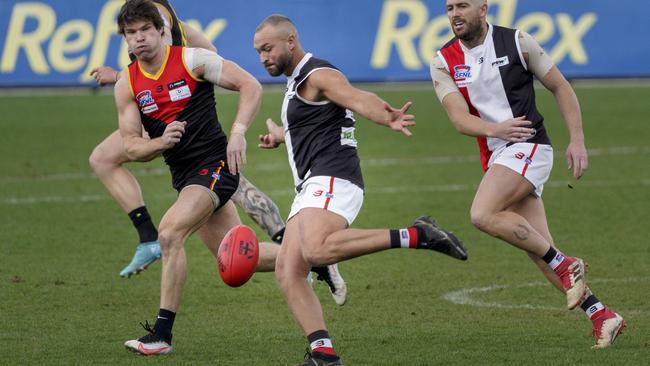 SFL: St Kilda City’s Madison Andrews gets a kick as Nathan Freeman of Dingley watches on. Picture: Valeriu Campan