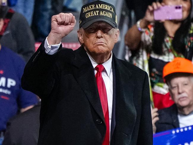 Former US President and Republican presidential candidate Donald Trump pumps his fist after speaking at the end of a campaign rally at Atrium Health Amphitheater in Macon, Georgia, on November 3, 2024. (Photo by Elijah Nouvelage / AFP)