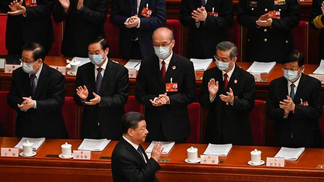 China's President Xi Jinping (bottom) is applauded as he arrives for the second plenary session of the National People's Congress.