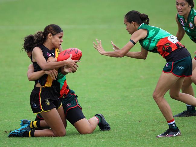 Anzac Day trophy winning Heidi Talbot is tackled in their Anzac Day clash between North Cairns Tigers and South Cairns Cutters at Watson's Oval. Picture: Jake Garland