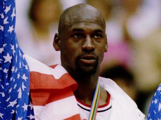 6 OCT 1992: USA BASKETBALL TEAM MEMBERS MICHAEL JORDAN (MIDDLE) SCOTTIE PIPPEN (LEFT) AND CLIDE DREXLER (RIGHT) ACKNOWLEDGE THE CROWD AFTER RECEIVING THEIR GOLD MEDALAS MEMBERS OF THE DREAM TEAM DURING THE 1992 BARCELONA OLYMPICS IN BARCELONA, SPAIN. Man