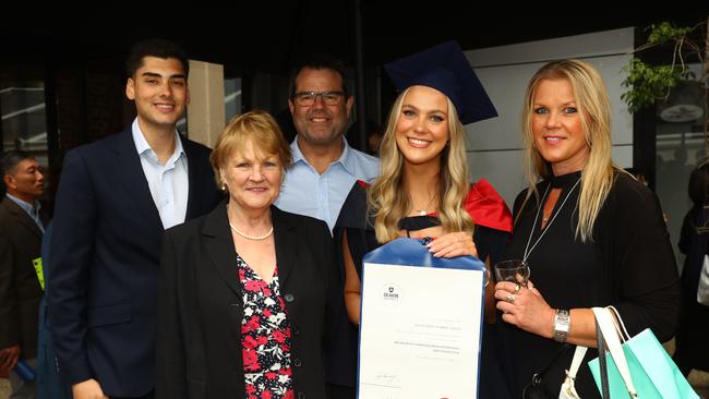 Graduate Julia Markic-Smith with boyfriend Andrew Enache, left, grandma Anne Markic, dad Brendan Smith and mum Lydia Markic at the Deakin University Graduation post ceremony celebration. Picture: Alison Wynd