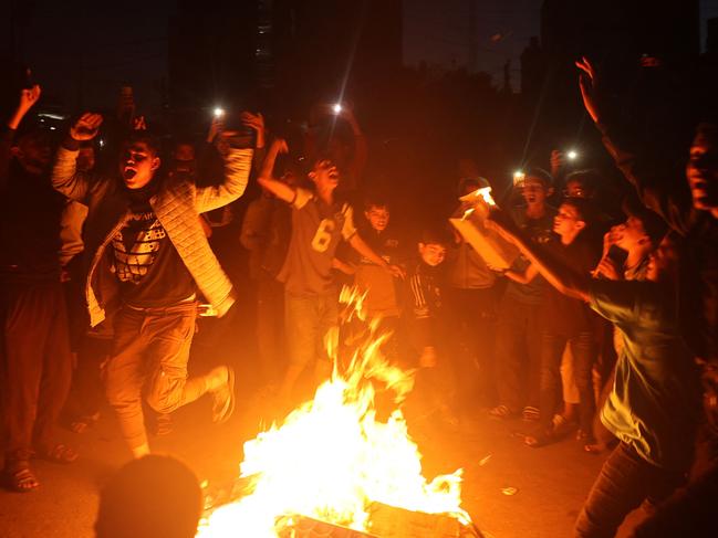 Palestinians celebrate in a street in Rafah, in the southern Gaza Strip, after Hamas announced it has accepted a truce proposal. Picture: AFP