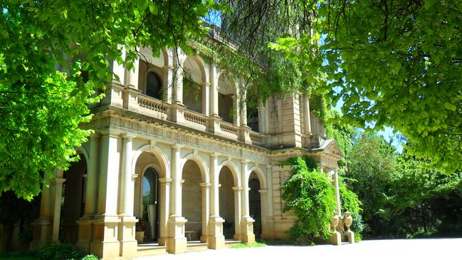 The mansion’s imposing facade is complete with a majestic tower, elaborately arched verandas and grand columns complemented by the surrounding gardens.