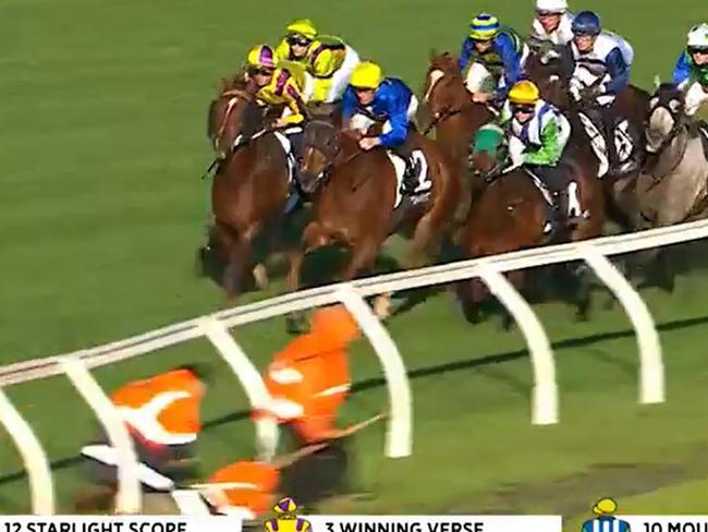 Caulfield track staff rush to get off the track during the running of race 7 on Saturday June 24. Picture: Racing.com