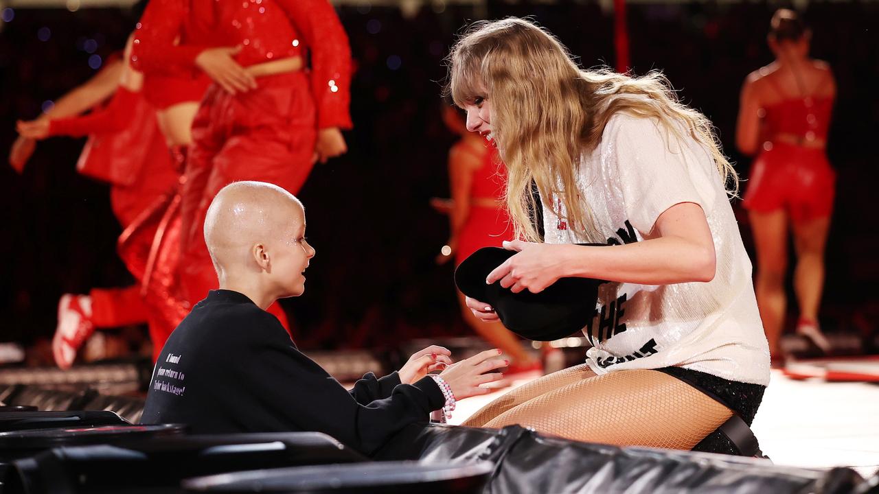 SYDNEY, AUSTRALIA - FEBRUARY 23: EDITORIAL USE ONLY. NO BOOK COVERS A young fan receives a hat from Taylor Swift during her performance at Accor Stadium on February 23, 2024 in Sydney, Australia. (Photo by Don Arnold/TAS24/Getty Images for TAS Rights Management)