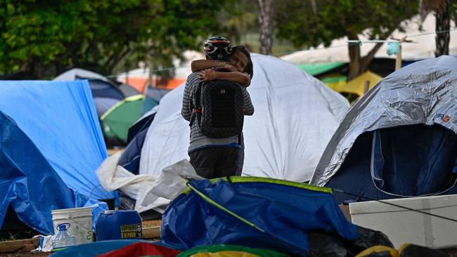 Supporters of Brazil's far-right ex-president Jair Bolsonaro embrace as soldiers dismantle the camp they had set up in front of the Army headquarters. Picture: AFP