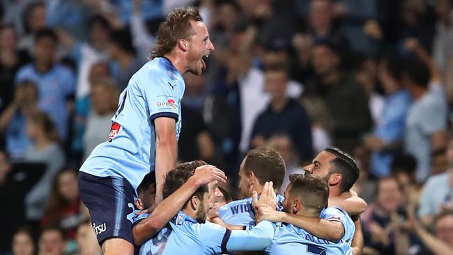 Rhyan Grant celebrates a goal from teammate Alex Brosque.