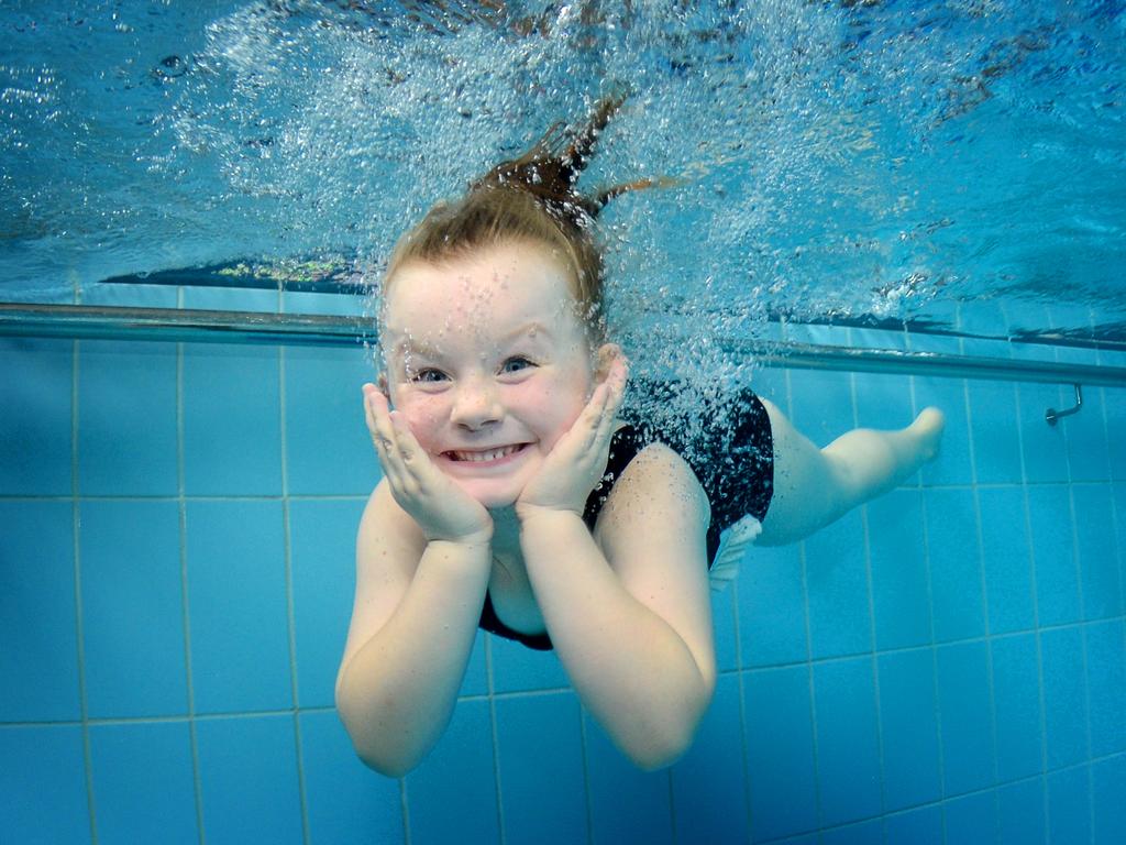 Kids smile for the underwater camera | Daily Telegraph