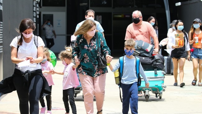Travellers are seen wearing face masks at Sydney International Airport. Mask mandates will be scrapped inside airports in Queensland, NSW and the ACT from this weekend.  Picture: NCA Newswire / Gaye Gerard