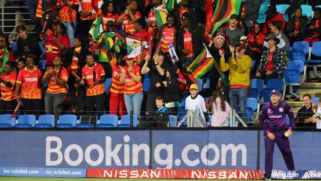 Zimbabwe fans cheer as Scotland's Mark Watt fields on the boundary line. Picture: David Gray/AFP