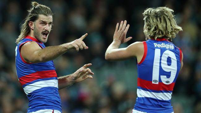 ADELAIDE, AUSTRALIA - MAY 15: Josh Bruce of the Bulldogs celebrates a goal with Cody Weightman during the 2021 AFL Round 09 match between the Port Adelaide Power and the Western Bulldogs at Adelaide Oval on May 15, 2021 in Adelaide, Australia. (Photo by Sarah Reed/AFL Photos via Getty Images)