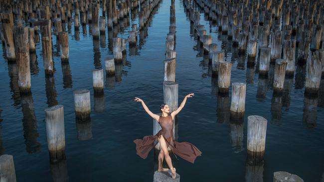 Self described tomboy Kristy Lee Denovan is not your typical ballerina with a sailor tattoo on her arm and standing only 1.6m tall. But she displayed all the grace and grit that saw her rise to principal dancer with the Melbourne Ballet Company as she stood on the century-old pilings at Princess Pier. Picture: Jason Edwards