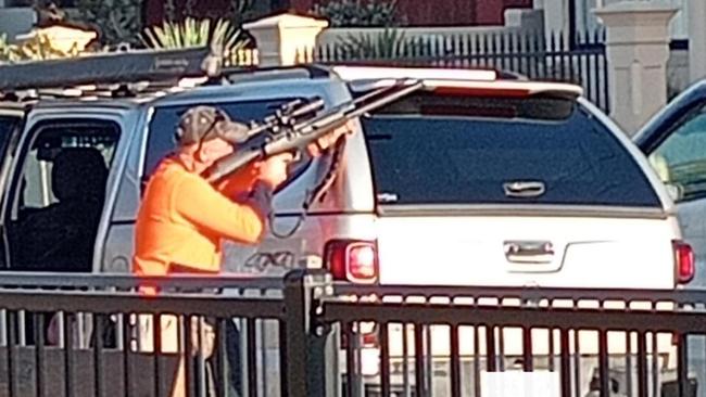 A photograph has emerged online of a man pulling out a gun next to a playground in Brighton, sparking panic among some residents. Picture: 7NEWS Adelaide