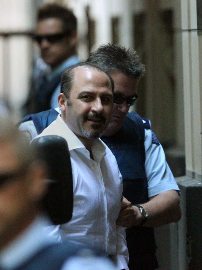 Mokbel looks up with a grin as he arrives at the Supreme Court in 2011.