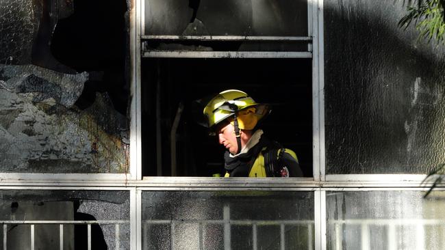 Fire in housing commission units at 339 George Street , Waterloo .Firemen look through the damaged windows .