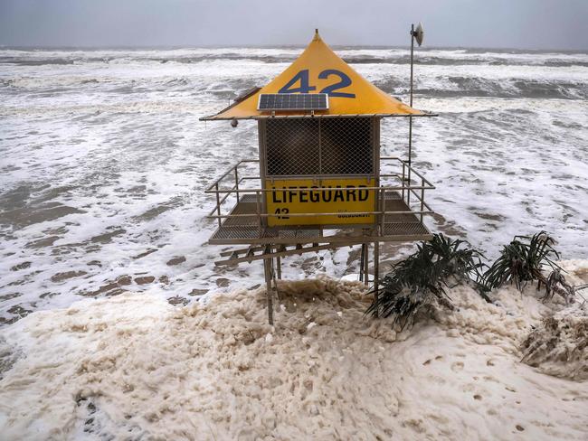 A lifeguard tower is surrounded by water on Main Beach, Gold Coast that has been damaged by record-breaking waves caused by the outer fringe of ex-tropical cyclone Alfred. Picture: Dave Gray / AFP