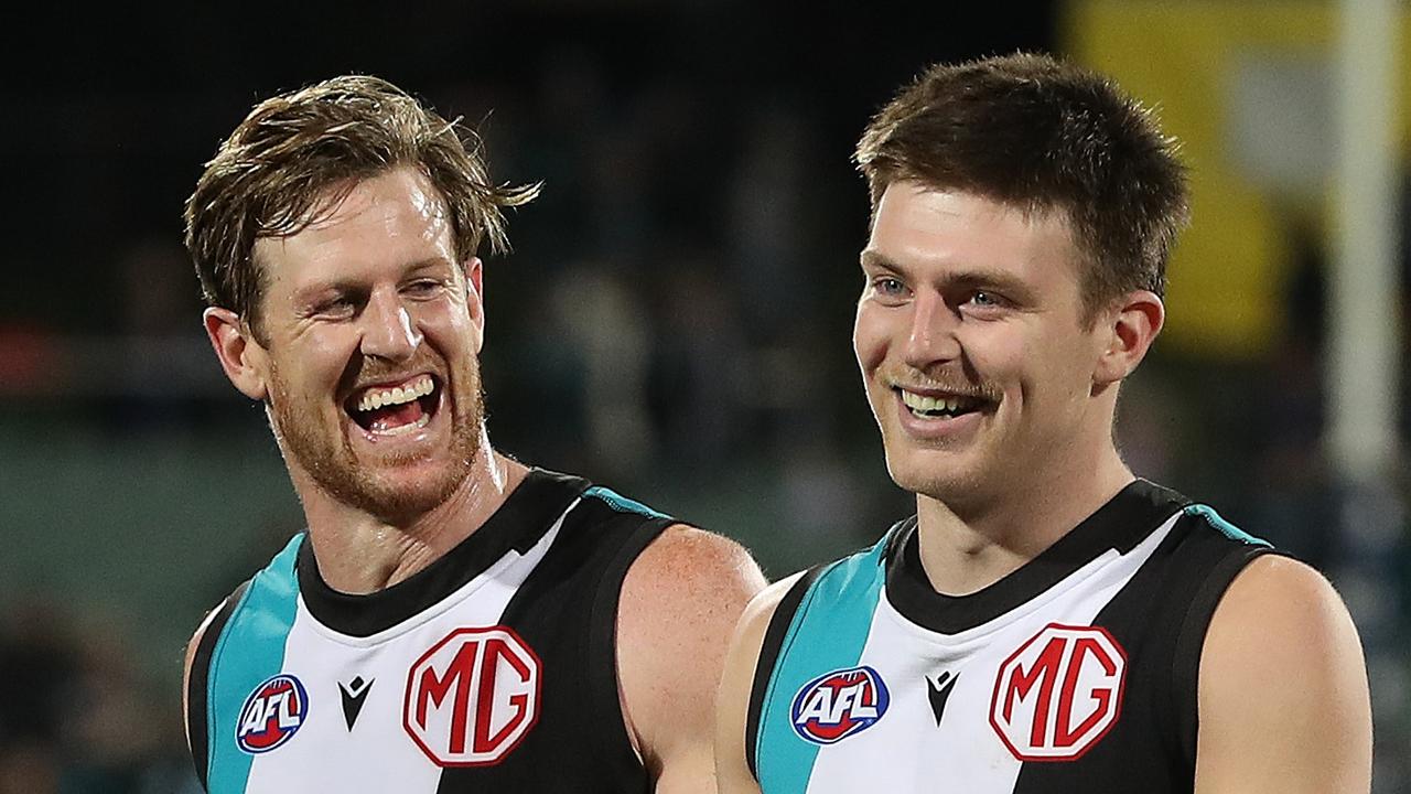 Dylan Williams pictured with Port skipper Tom Jonas. Picture: Sarah Reed/AFL Photos via Getty Images