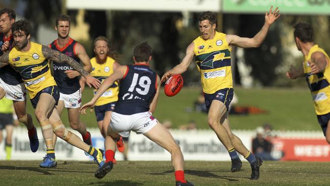 SANFL: Eagles v Norwood at Woodville Oval. Eagle's Louis Sharrad kicks towards goal as Norwood's Tom Forster attempts to smother the kick. 18 May 2019. (AAP Image/Dean Martin)