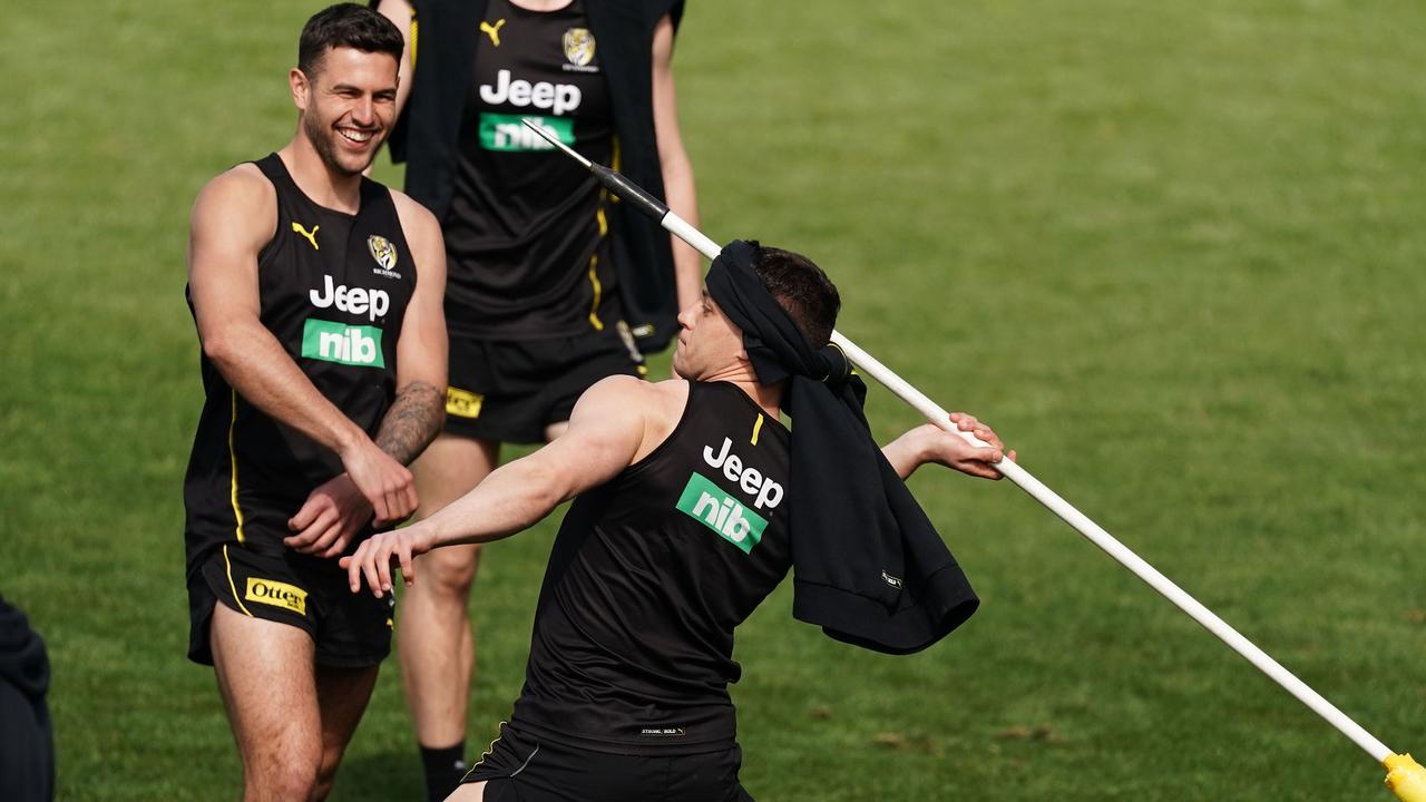 Dion Prestia turns a training pole into a javelin in the Tigers’ lighthearted session on Monday. Picture: AAP Image