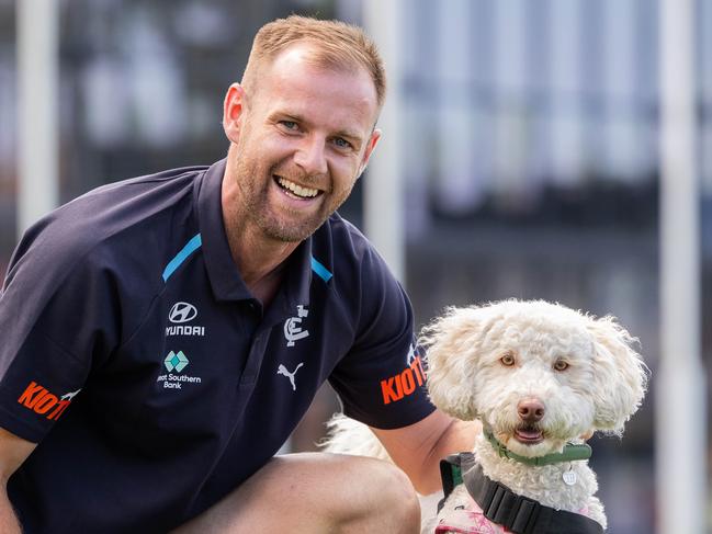 Sam Docherty with Pebbles, 2 year old labradoodle Animal Assisted Education Therapy Dog. Carlton footballer Sam Docherty is donating $30,000 to Peter Mac for cancer research and $10,000 to McKillop Family Services. It is from his Jim Stynes award - Sam had cancer and will be pictured with a 23-year-old Blues fan Liam Contarin who was diagnosed with the same cancer around the same time. Picture: Jason Edwards