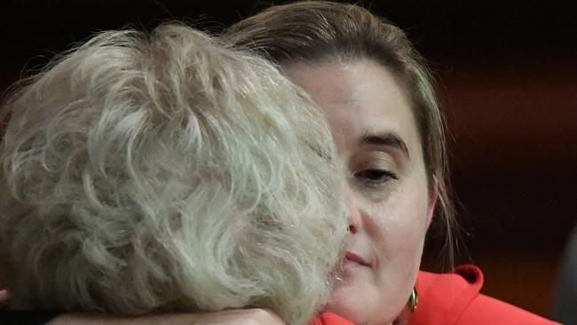 Cr Cathy Oke (right) is hugged by Cr Susan Riley at a city council meeting this week.