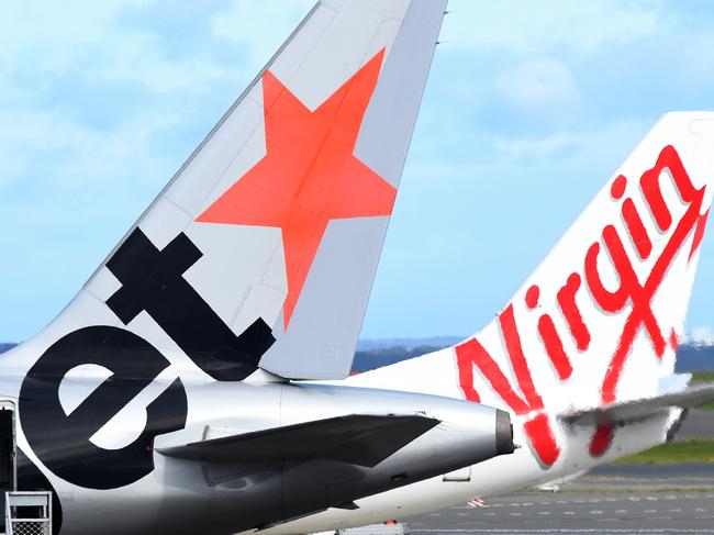 SYDNEY, AUSTRALIA - NCA NewsWire Photos JULY, 28, 2020: A Jetstar and Virgin Australian Aircraft are seen on the tarmac at Sydney Airport. An infectious woman who flew from Melbourne to Sydney, on Jetstar flight JQ506 on July 25th, has tested positive to COVID-19 (Coronavirus). Picture: NCA NewsWire / Bianca De Marchi