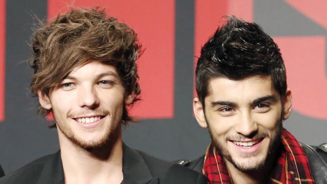 FILE - This Nov. 3, 2013 file photo shows One Direction members Louis Tomlinson, left, and Zayn Malik during an event for their film "One Direction: This Is US," in Makuhari, near Tokyo, Sunday, Nov. 3, 2013. A representative for One Direction says the band’s lawyers are dealing with a video showing two band members smoking what the singers referred to as an “illegal substance.” British tabloid The Daily Mail posted a five-minute clip Tuesday, May 27, 2014, of Zayn Malik smoking and speaking with Louis Tomlinson, who is filming. (AP Photo/Koji Sasahara, File)