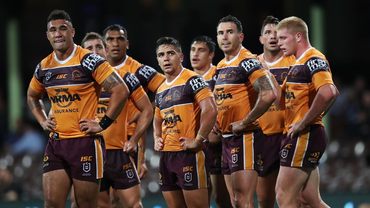 Dejected Broncos players try to digest their record thrashing at the hands of the Roosters at the SCG. 
