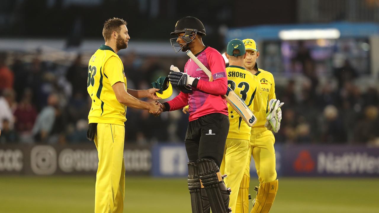 Abi Sakande of Sussex shakes hands with Andrew Tye of Australia.