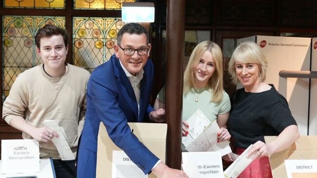 The image of Daniel Andrews and his family in which the exit sign appears blurred out.