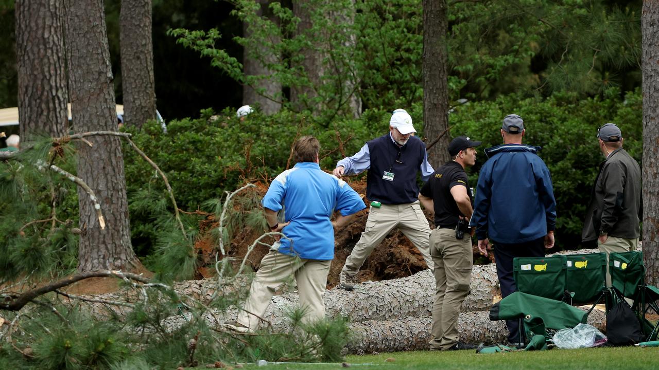 Course officials look over fallen trees on the 17th tee at Augusta. (Photo by Patrick Smith/Getty Images)