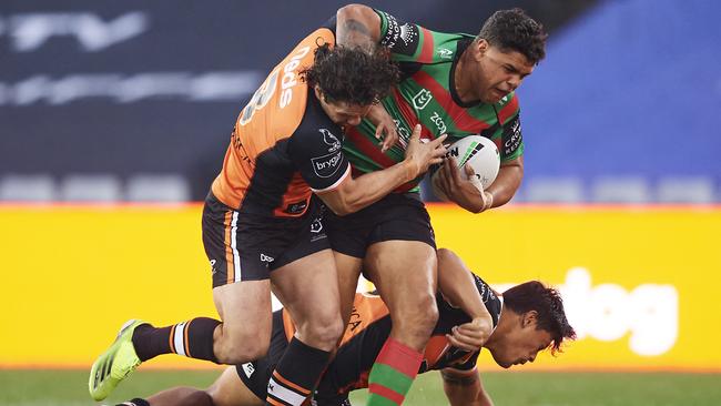 SYDNEY, AUSTRALIA - APRIL 17: Latrell Mitchell of the Rabbitohs is tackled during the round six NRL match between the South Sydney Rabbitohs and the Wests Tigers at Stadium Australia, on April 17, 2021, in Sydney, Australia. (Photo by Brett Hemmings/Getty Images)