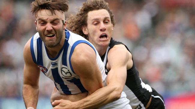 Chris Mayne lays a strong tackle on Luke McDonald. Picture: AAP