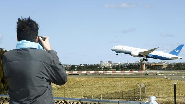 Plane spotters’ watching the runway from Shep’s Mound. Picture: John Appleyard