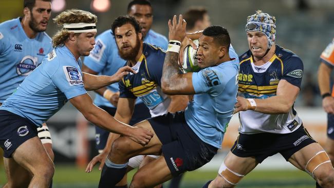 Folau rolls out of a Pocock tackle in Canberra. Picture: Kym Smith