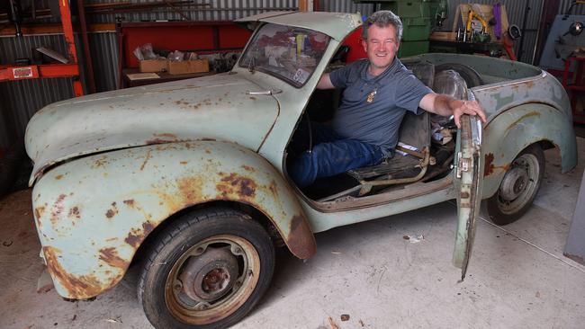 National Motor Museum curator Matthew Lombard with a 1950/51 Hartnett Pacificwhich is being restored at the Birdwood workshop while the museum is shut down. Picture: AAP /Mark Brake