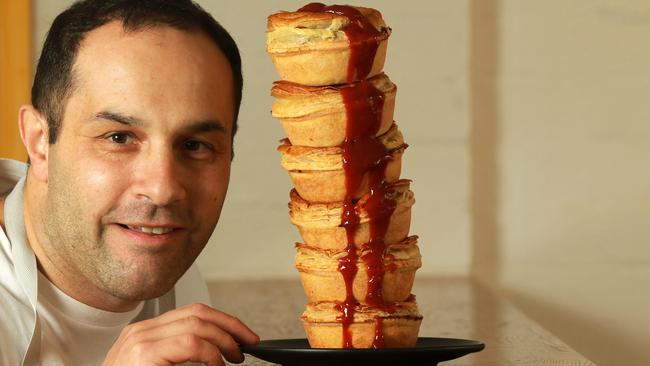 Owner Orlando Artavilla of Candied Bakery in Spotswood admires a stack of traditional beef pies. Photo: Janine eastgate