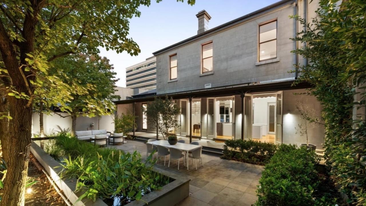 French doors at Cumnock open to a private, sun-drenched courtyard with a fish pond centrepiece and lush landscaped gardens.