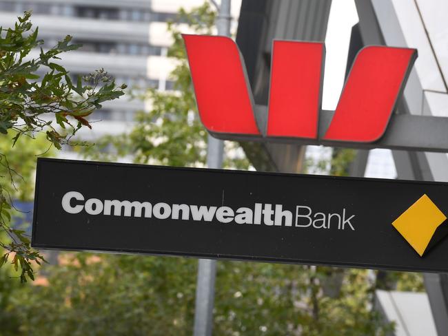 Signs adorn the branches of a Westpac and Commonwealth banks in Melbourne on February 4, 2019. - Australian banks admitted to failing customers and vowed to "reset" their industry, as they braced for the release of a crunch report on February 4, into financial abuses in the sector. (Photo by William WEST / AFP)