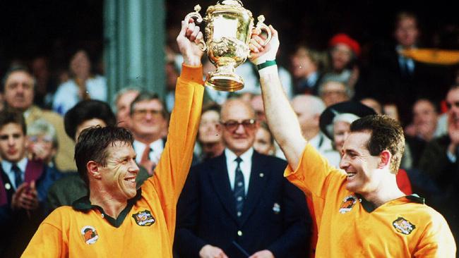 Nick Farr-Jones, left, and David Campese with the World Cup in 1991. The gold jersey of that era has been locked in as the colout to be used heading into the future