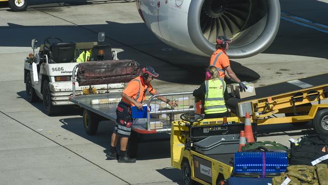 Qantas airport baggage handlers wearing protective gear while the supervisor (Not Sure) but looks as if he was giving orders was not wearing any protective gear at all and was not practising safe distance rules.Thursday April 2 2020.PIC SUPPLIED