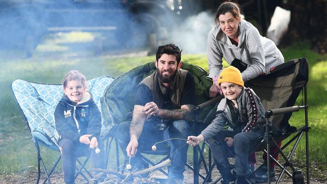 Emma Young and partner Steve Black with their children Emily, 9, and Lucas, 10, toast marshmallows on their fire at Chalks Campground, Mount Crawford. Picture: Mark Brake