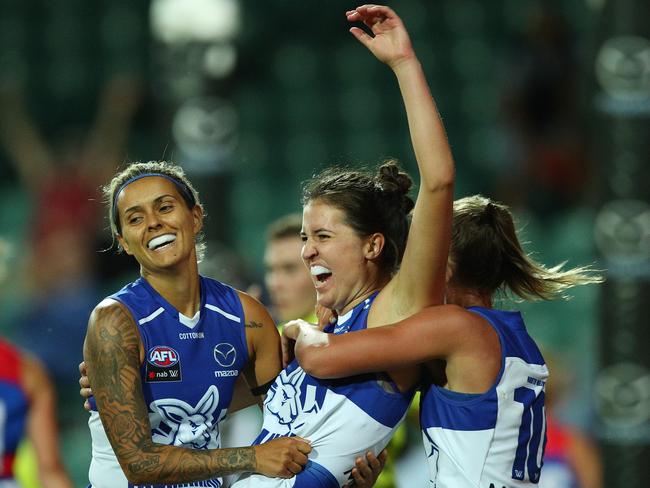 Kangaroos swamp Courteney Munn after she booted one of her matchwinning four goals. Picture: Getty Images