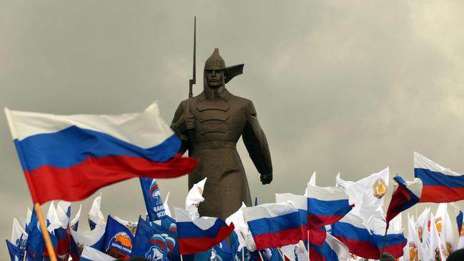 Pro-Kremlin activists hold Russian flags near a monument to Red Army soldier as they rally in the southern Russian city of Stavropol, in 2014, to celebrate the incorporation of Ukraine’s Crimea. Picture: AFP