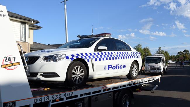 A police car damaged in the street is towed away. Picture: Nicole Garmston