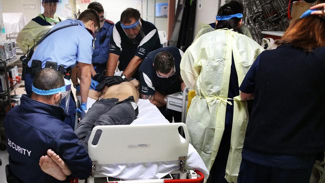 Nine medical staff and security try to control an ice addict in a state of psychosis in the Emergency Department of Royal Perth Hospital. Picture: Gary Ramage