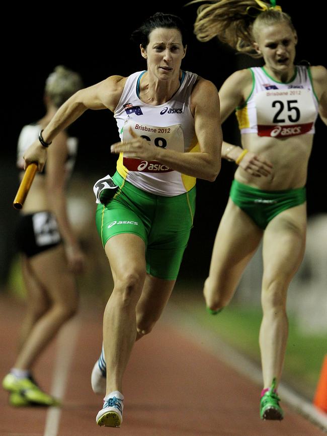 Jana Pittman takes the baton of Caitlin Sargent in the 4 x 400 at the Brisbane Track Classic in 2012.