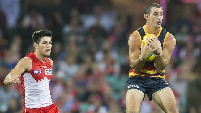 Adelaide co-captain Taylor Walkers marks in front of Sydney defender Lewis Melican.