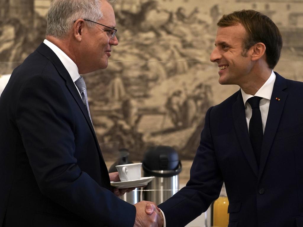 Australian Prime Minister Scott Morrison and French President Emmanuel Macron talk before the G20 leaders make a short visit to the Fontana di Trevi to throw a coin in the fountain. Picture: Adam Taylor